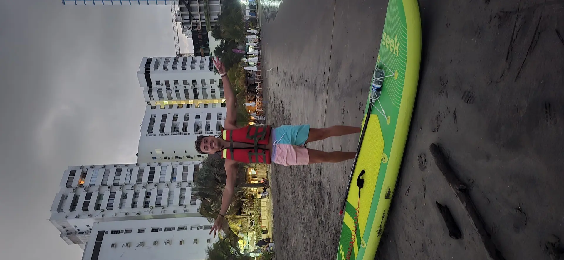 Customer with paddleboard and safety vest