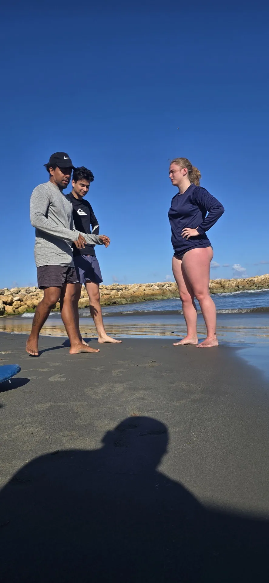 Students practicing surf stance on the beach