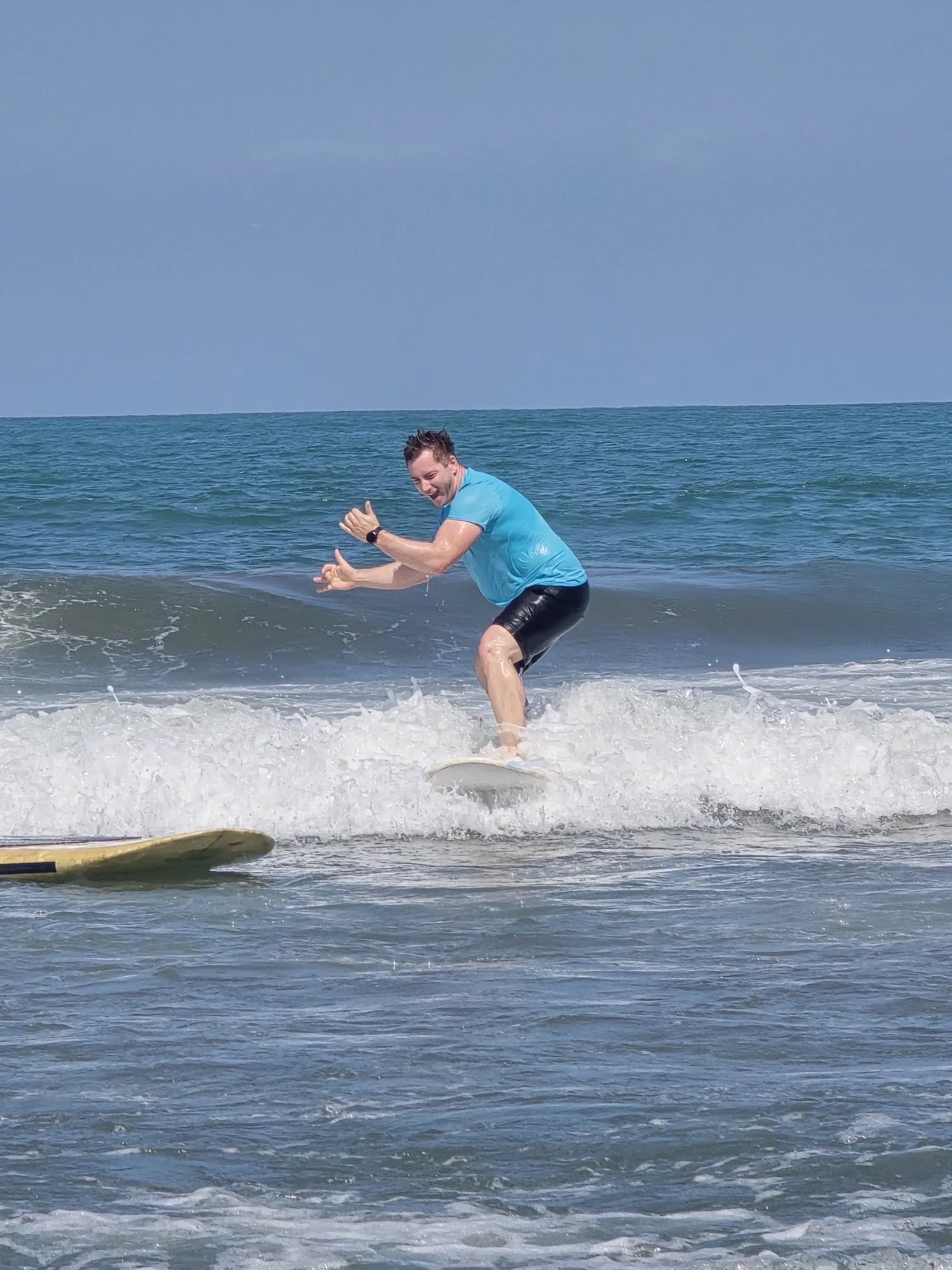 Surf student standing up on a whitewater wave in Cartagena